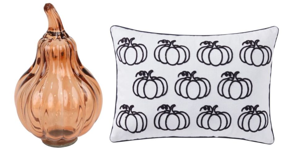 a glass pear and a white and black pumpkin printed pillow cover