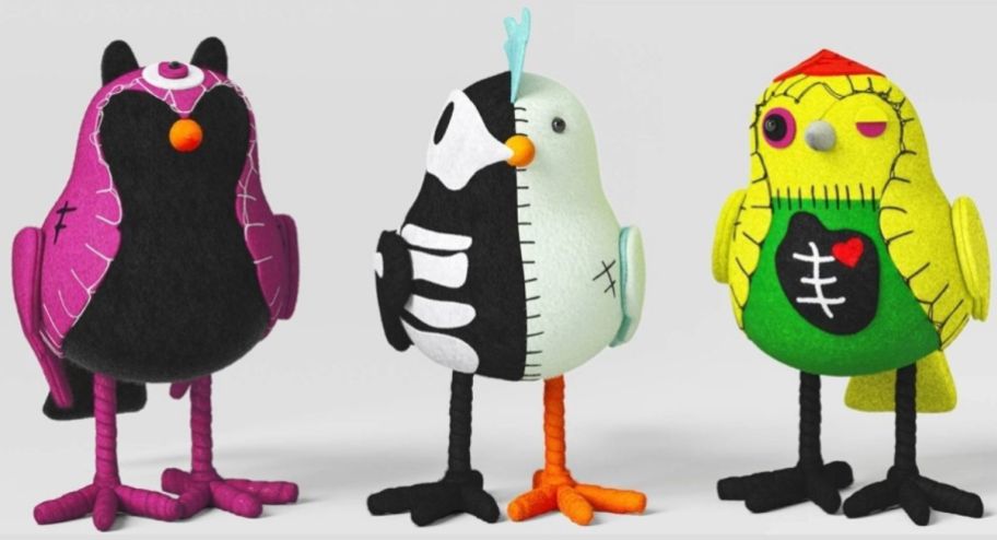 three felt bird figurines dressed in halloween costumes