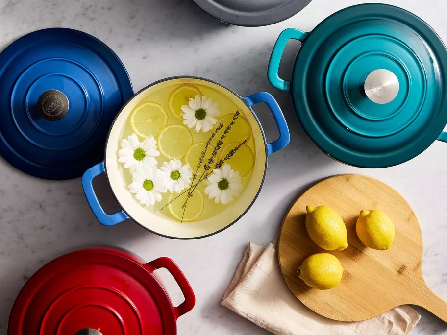 blue, teal, red dutch ovens on table 