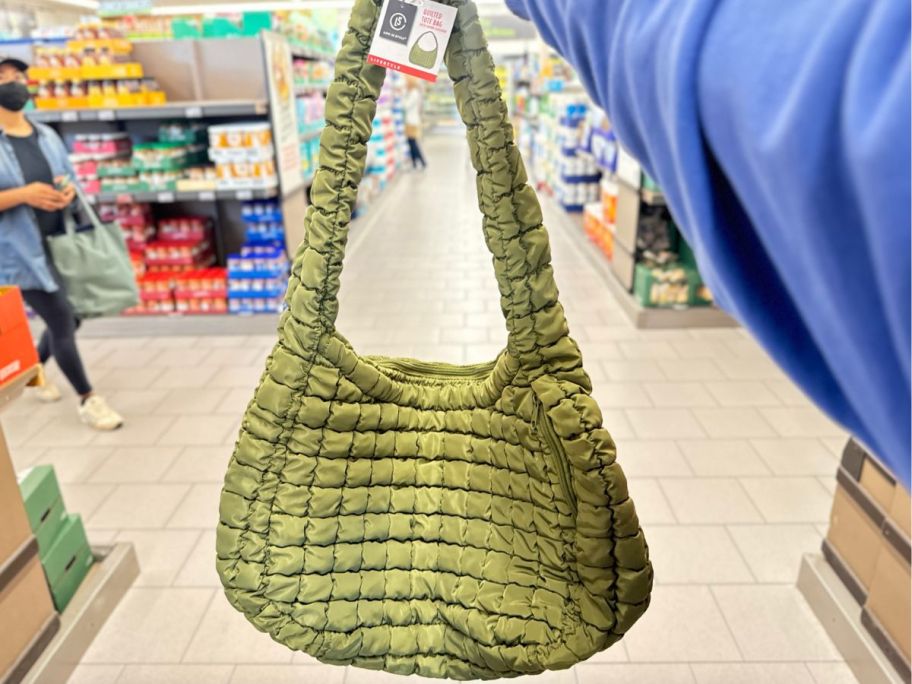 hand holding bag in green