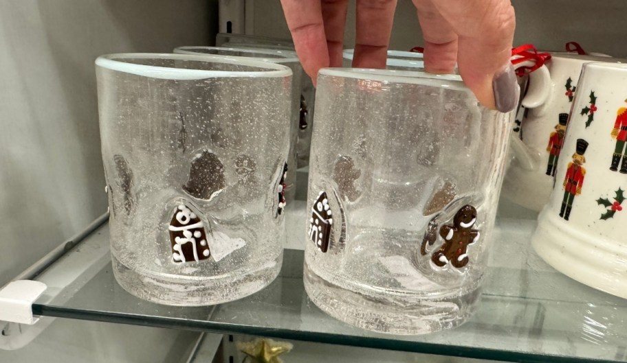 woman hand reaching for a rocks glass