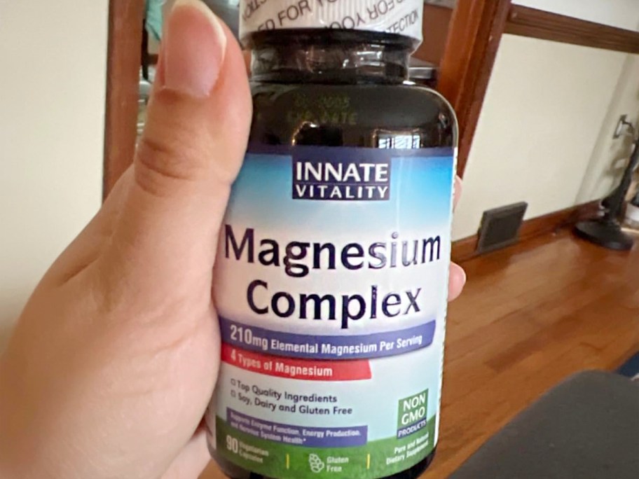 hand holding magnesium complex bottle 