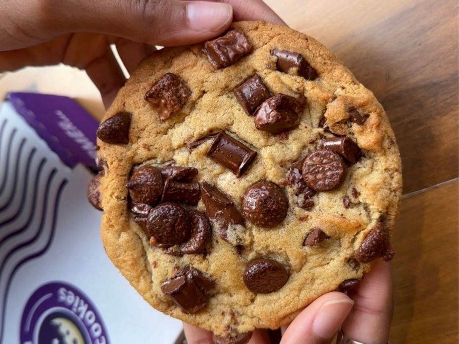 hand holding deluxe insomnia cookie