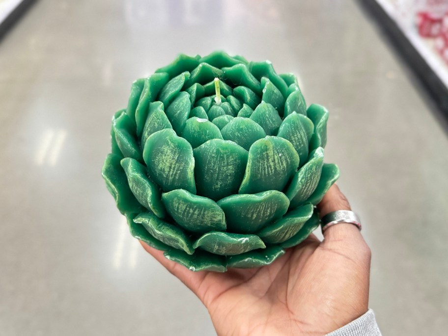 hand holding artichoke candle 