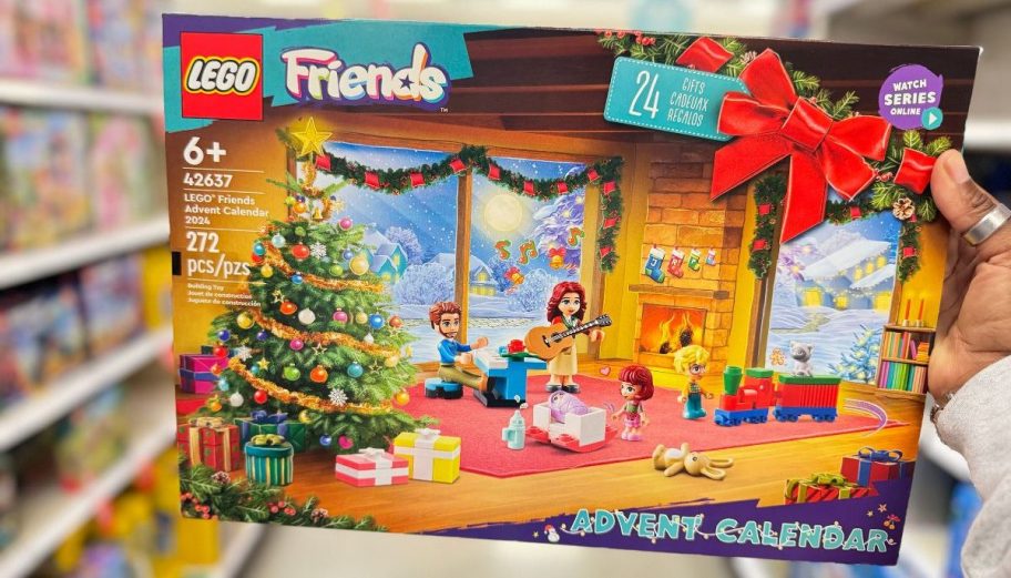 a womans hand holding a LEGO friends advent calendar box