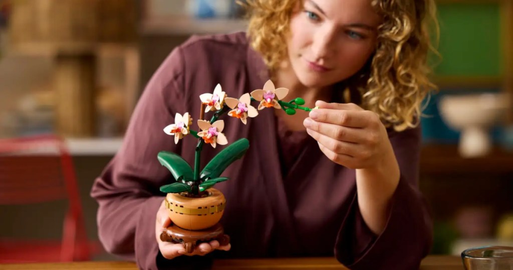 woman holding lego mini orchid