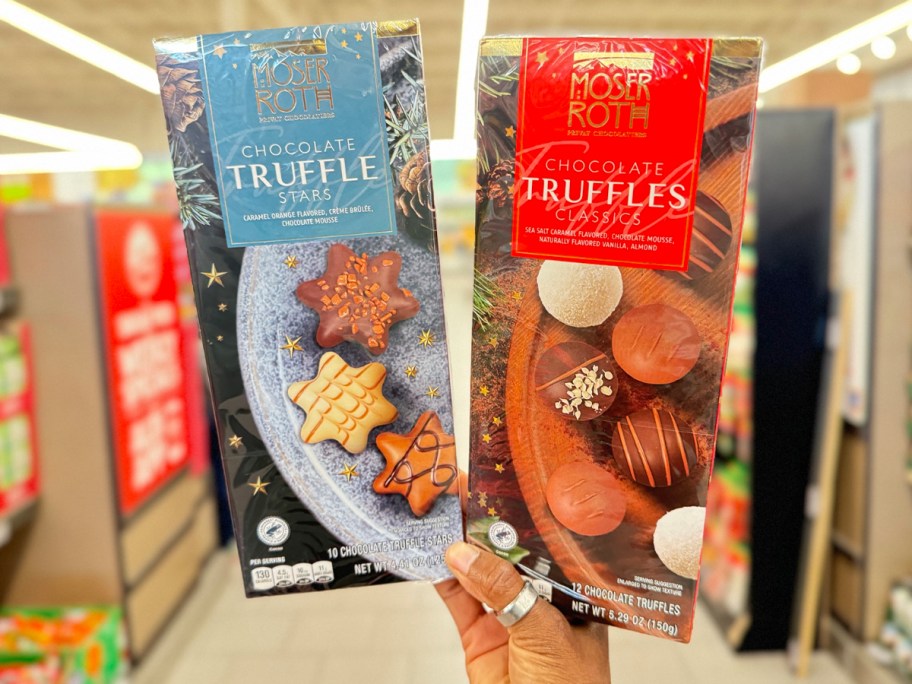 hand holding two boxes of star truffles 