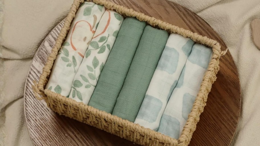 a 6 pack of baby blankets folded and placed in a woven baskets