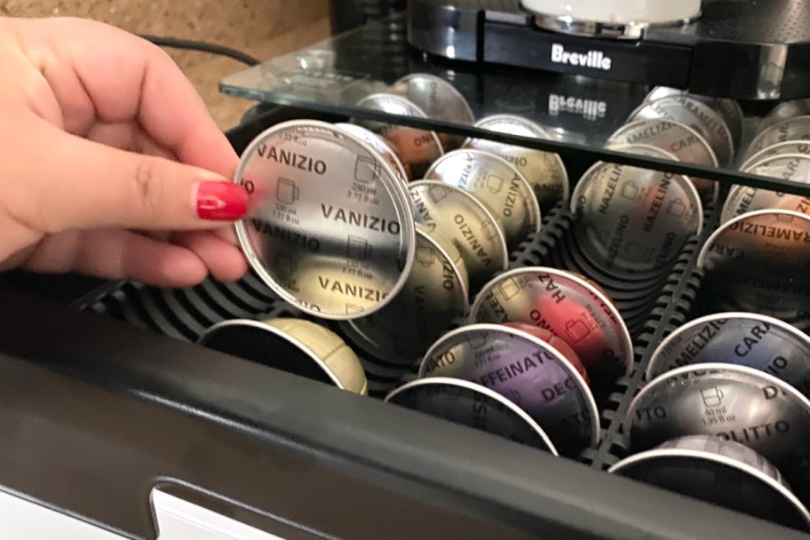 hand grabbing nespresso pod