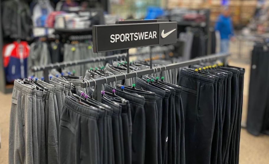  nike mens fleece pants on a rack in a store