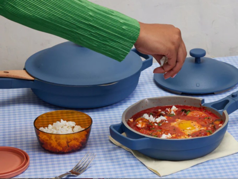 hand putting spice in blue pot