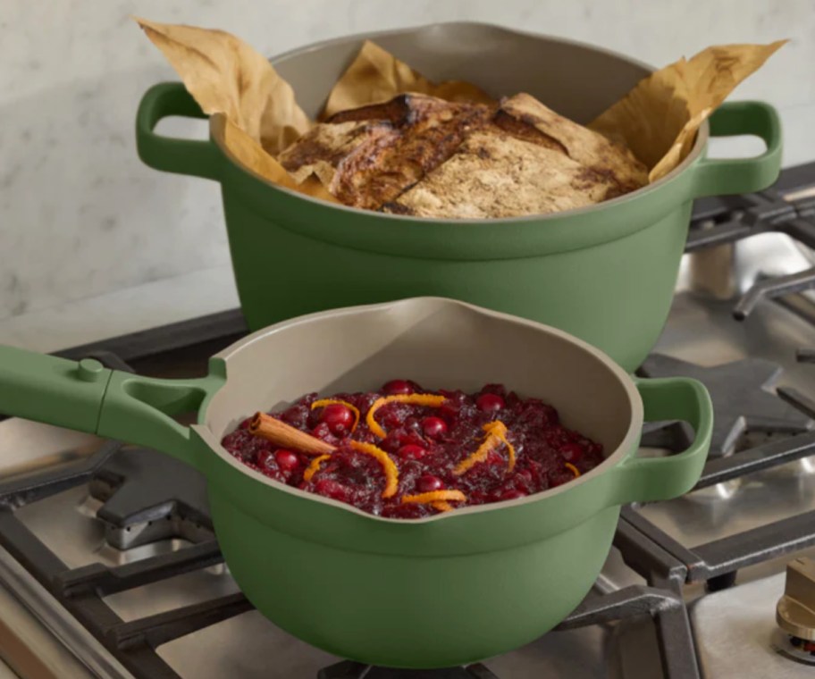 two green ceramic pots with food in them