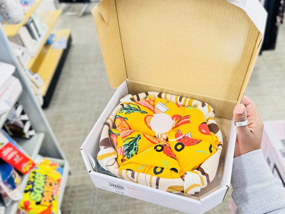 hand holding pizza box with socks 