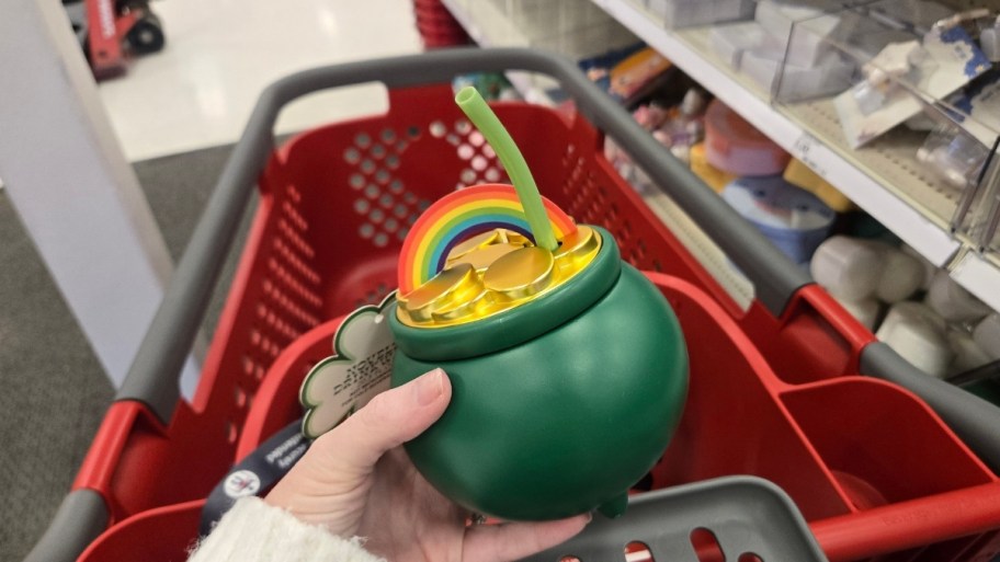 womans hand holding a pot of gold drinkware cup with straw