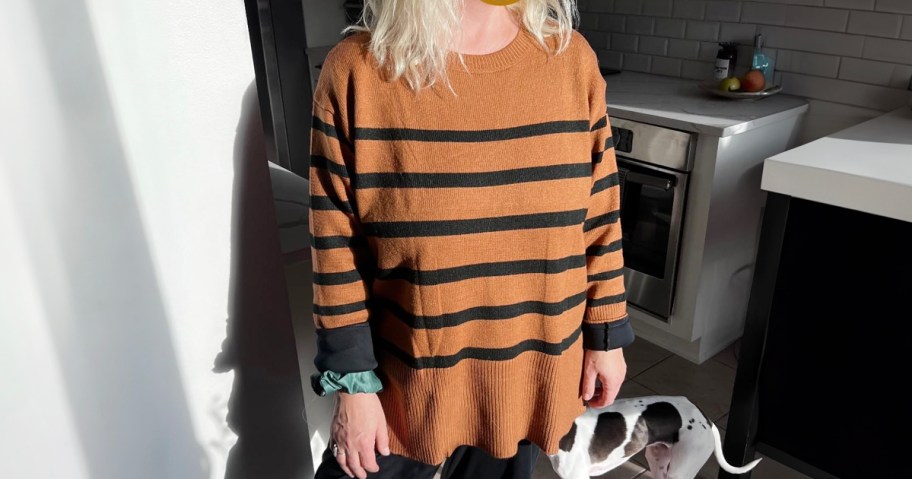 woman wearing orange and black striped oversized sweater in kitchen 