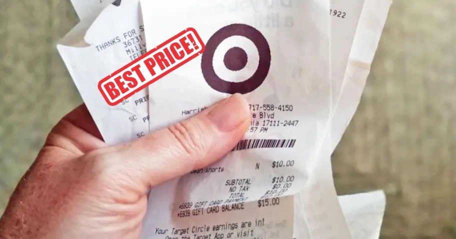 Hand holding a stack of target receipts with best price stamp on top 