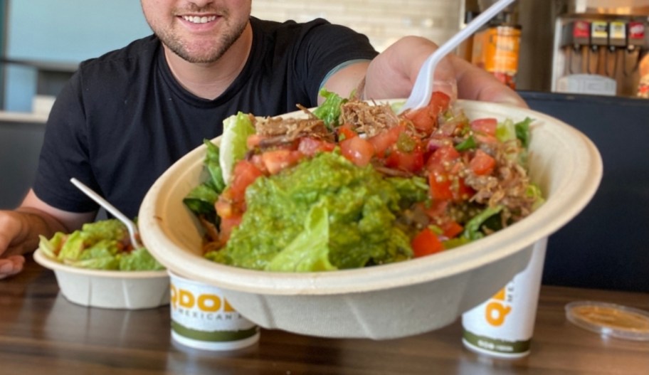a man passing a bowl of food