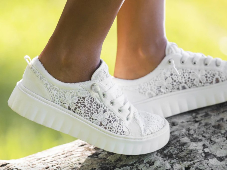 white sneakers on log