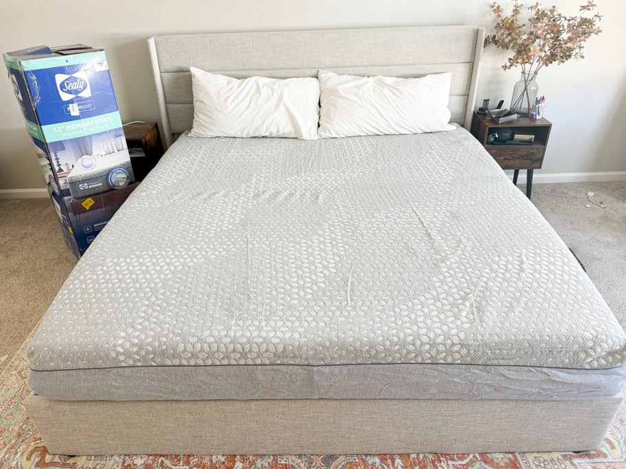 gray sealy mattress in bedroom with white pillows and box 