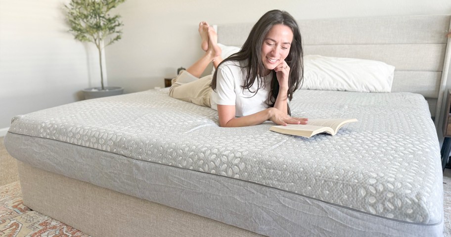 woman laying down on gray sealy mattress