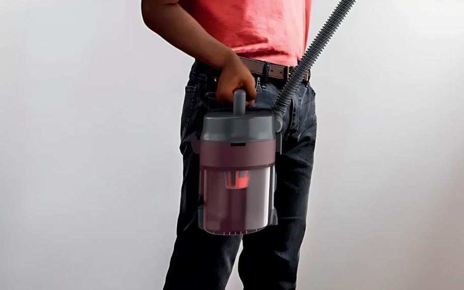 a man using the Shark messmaster wet dry vacuum