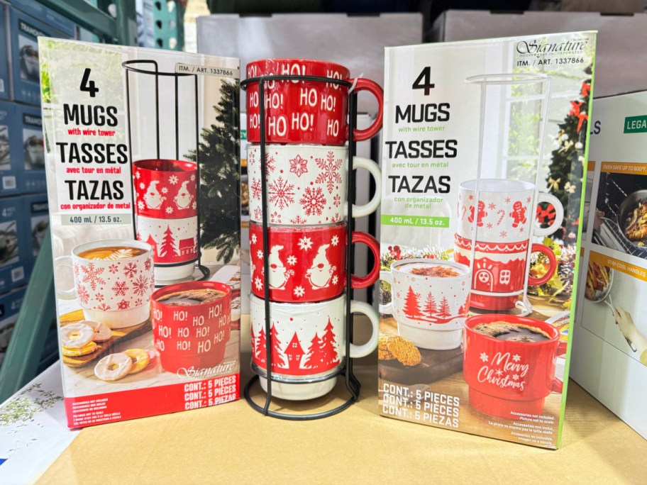 two boxes of stacking christmas mugs on either side of a display of stacking christmas mugs at costco