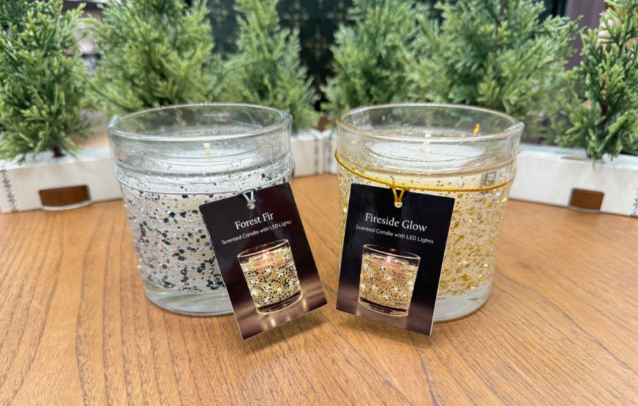 two led gel candles on a table in front of trees at target