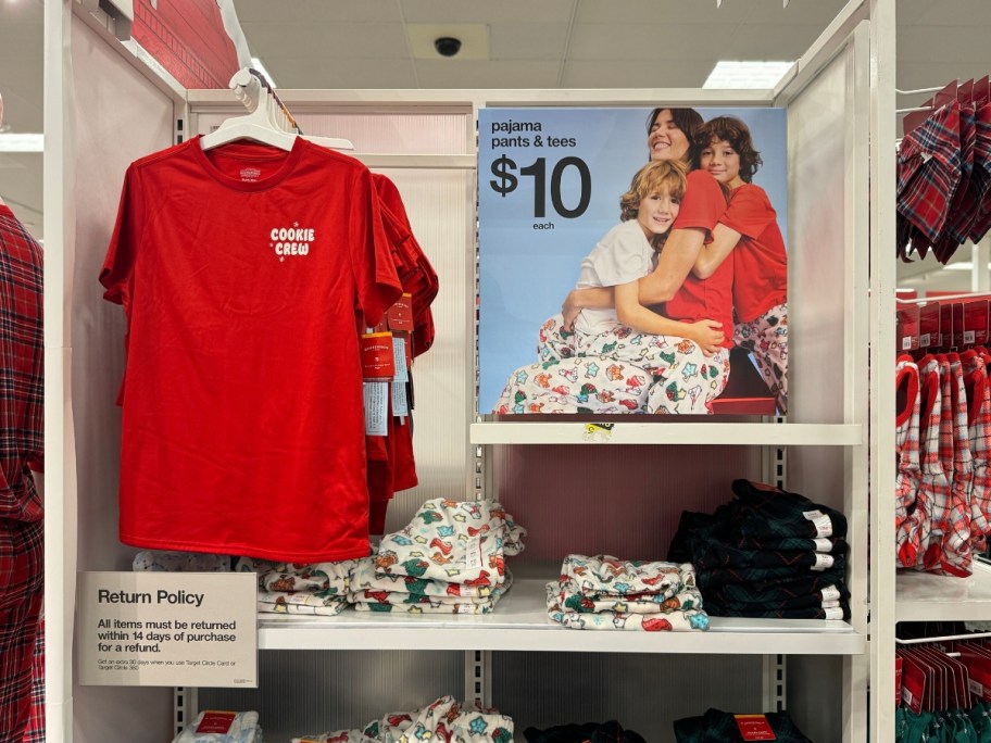 matching Christmas tshirts and pajama pants with holiday cookies and candy the shirt says "Cookie Crew" on display in Target