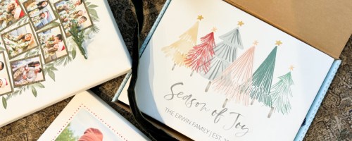 many photo canvases on floor with one in a box