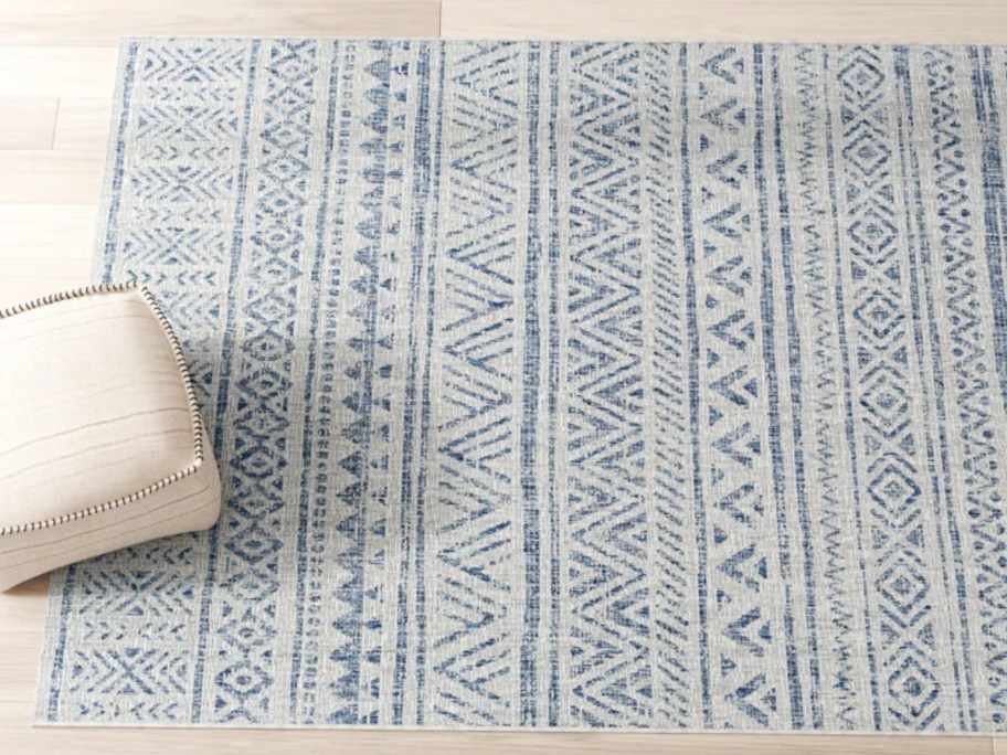 a blue and cream geometric area rug 