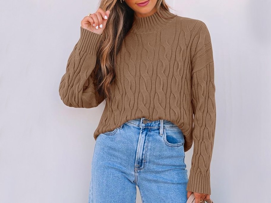 woman wearing brown sweater and jeans 