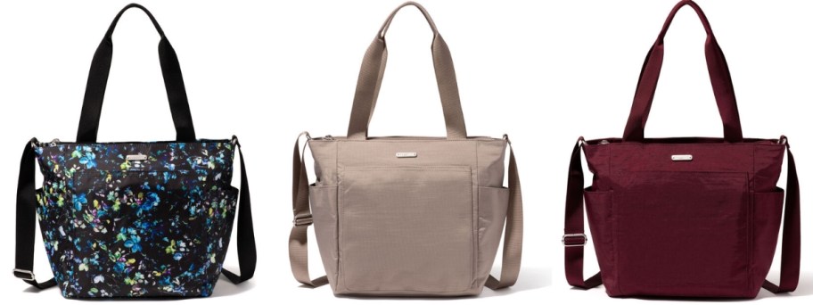 3 Baggallini tote bags, one is black with blue flowers, one is tan, and one is a dark red