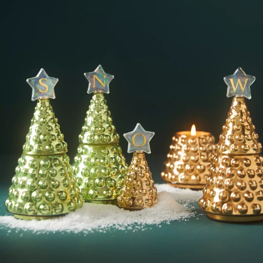 glass tree shaped candles with a monogrammed star on top