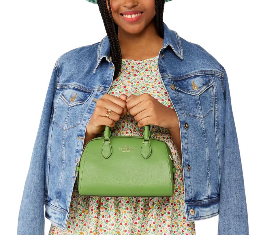 a woman with a small lime green duffle