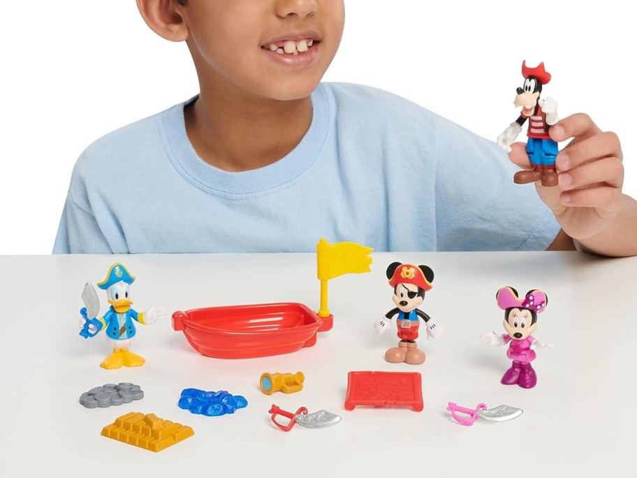 little boy playing with a Mickey Mouse Pirate Adventure Figure Set