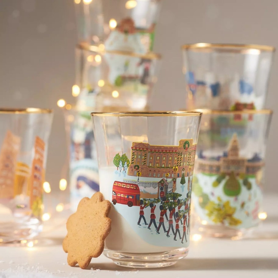 several juice glasses with winter Christmas scenes from large cities like Philadelphia, Washington, and New York