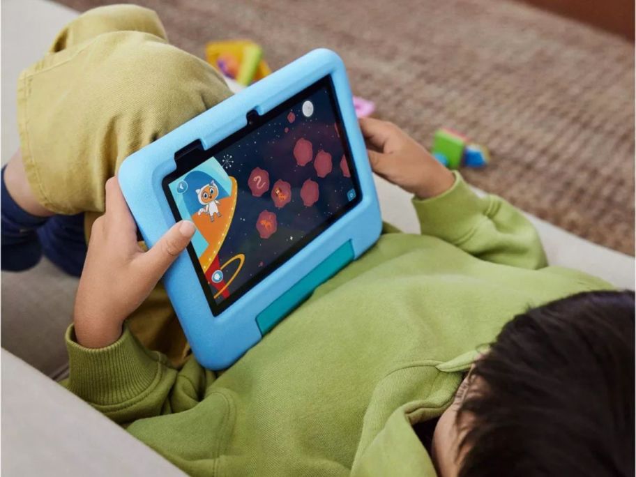 kid using Amazon Fire 7" Kids Tablet on lap