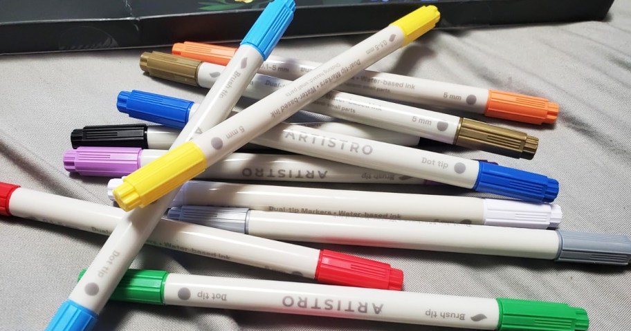 pile of acrylic pens in a rainbow of colors