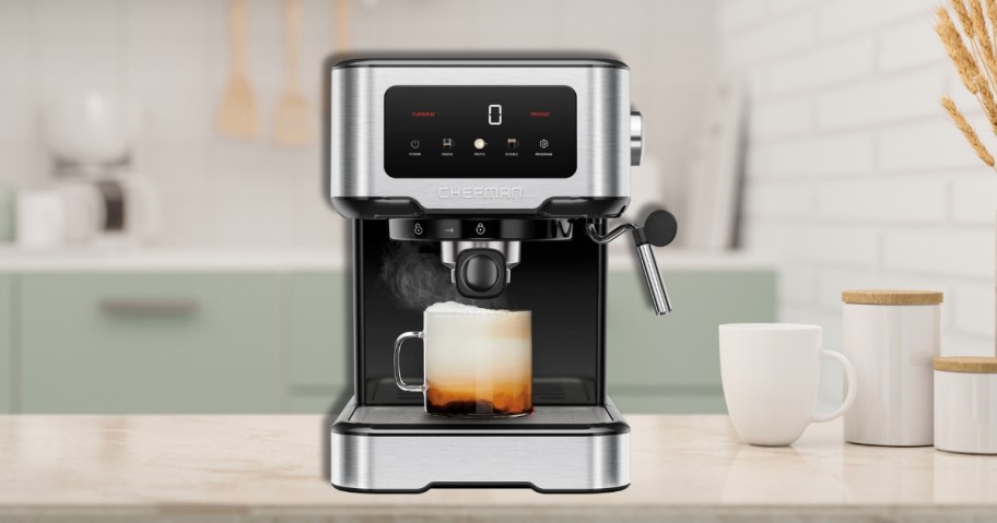 a silver and black espresso machine on a kitchen counter, cup of espresso in the maker