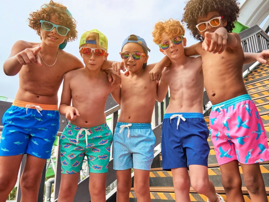 group of boys wearing chubbies swim trunks at beach