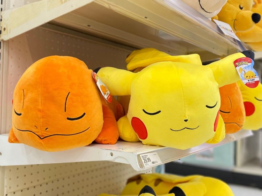 Cuddleez Target Pokemon Sleeping Plush Pillow in Charmander and Pokemon on a shelf