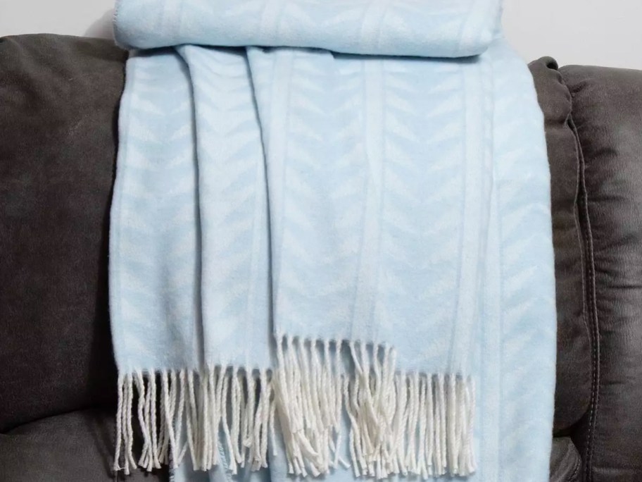light blue throw blanket draped over a couch