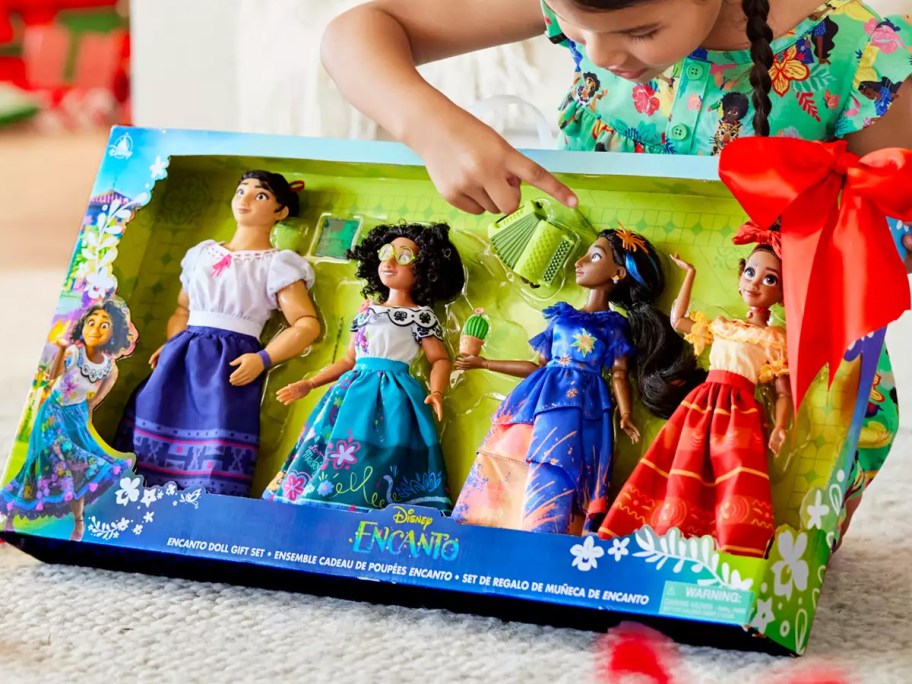 girl unwrapping a Disney Encanto 11