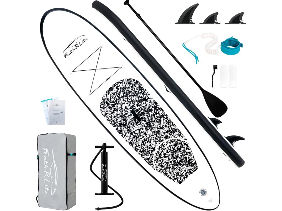 black and white paddle board with accessories around it