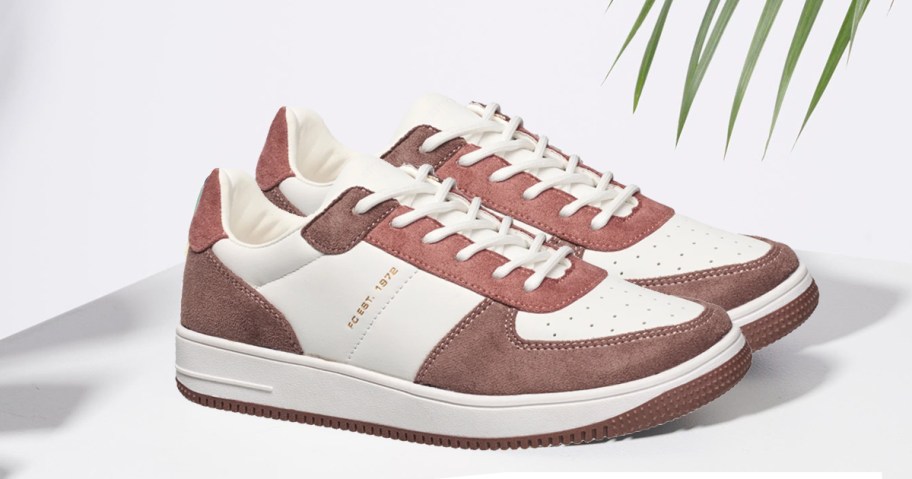 pair of brown and white sneakers on white table