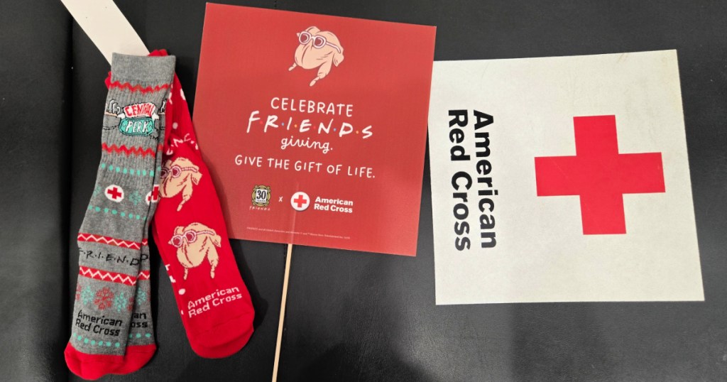 2 pairs of friends socks next to american red cross sign