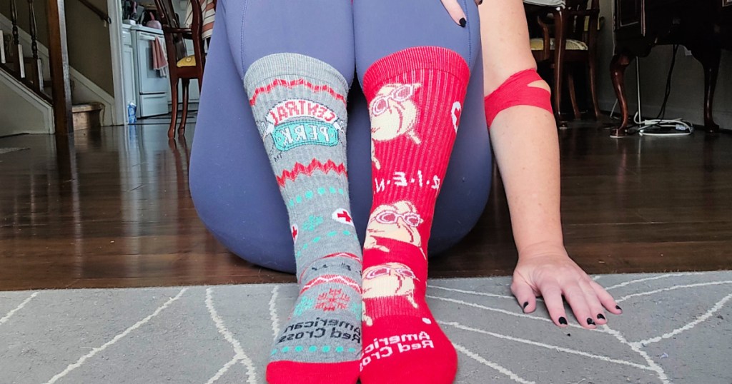 woman in leggings wearing 2 different friends socks