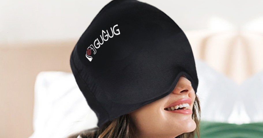 woman wearing a black migraine relief cap