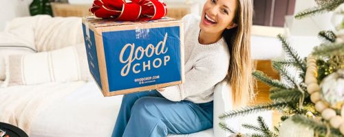 Woman holding a Good Chop Box with a big red bow on it