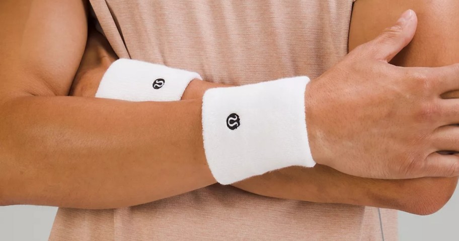 man's arms crossed wearing white lululemon Cotton Terry Wristbands